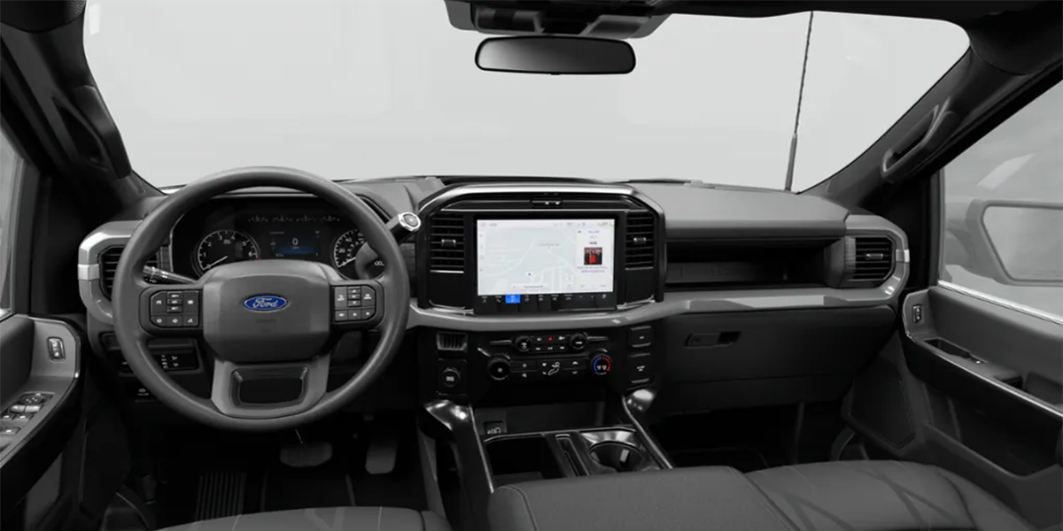 Inside view of a Ford truck's dashboard featuring a digital display and navigation controls.