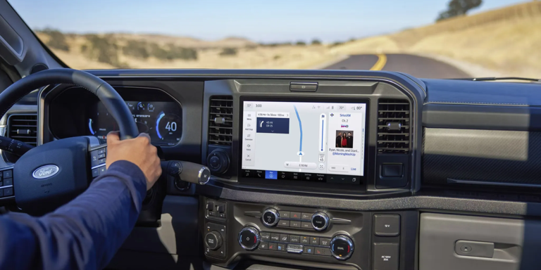 Inside view of a Ford truck's dashboard featuring a digital display and navigation controls.
