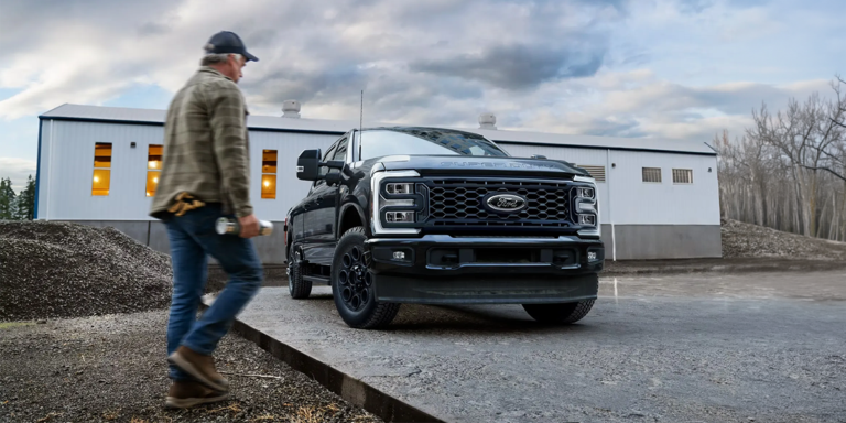 A black 2026 Ford F-150 pickup truck parked outside MSA Ford dealership, highlighting reliable vehicles and professional automotive services.